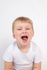 Cute child boy shows opened mouth close-up, tongue, baby white healthy teeth. The concept of oral hygiene, healthy teeth