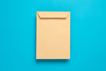 Craft postal envelope on blue background