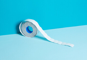 Roll of adhesive price sticker on blue background