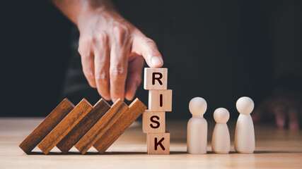 Business Crisis, Risk Management Concept. Hand stopping wooden domino protect crisis effect,...