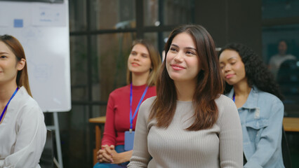 Beautiful young woman listening in seminar at meeting room. She looking to speaker with smiling.