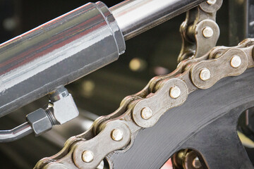 Metal chain and gear in agricultural or industrial machine. Technology