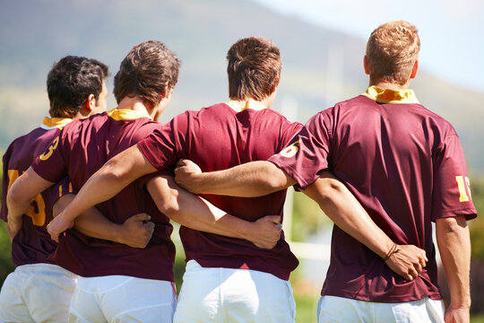 Back, rugby team and sports with men in a line outdoor on a field before a game or competition in summer. Teamwork, sport and unity with male athletes or players getting ready for training or a match