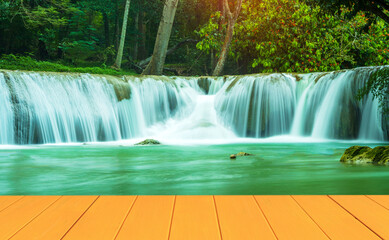 Natural wood floors and a beautiful waterfall in the middle of the forest.