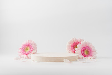 Wooden round podium pedestal cosmetic beauty product presentation empty mockup on  white background with gerbera flowers