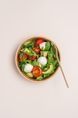 Cardboard bowl container with fresh caprese salad. Food delivery, zero waste, recycling packaging,...