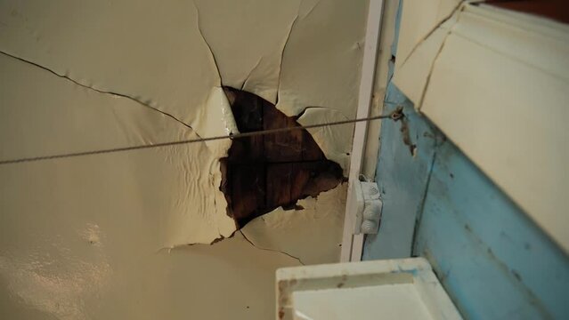 Broken ceiling problem in house because rain water damage in raining season. Selective focus