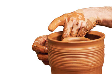A man in old medieval Byzantine clothes sits behind a vintage potter's wheel and makes dishes out...