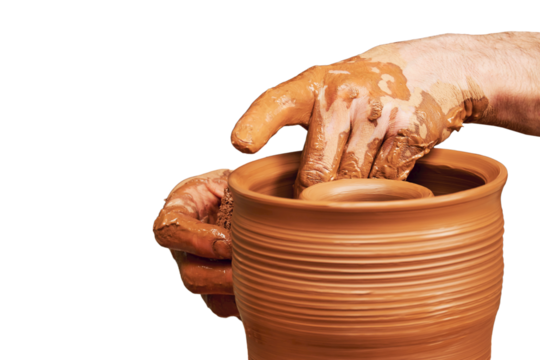 A man in old medieval Byzantine clothes sits behind a vintage potter's wheel and makes dishes out of clay, isolated on a white background. Pottery in nature in retro style.