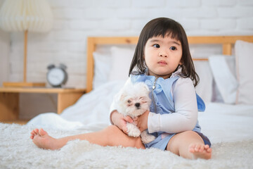 The little girl's eyes sparkled with joy as she held her furry friend close, cherishing the special...