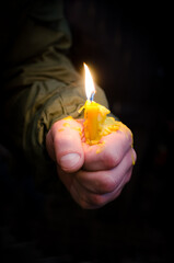 Memorial Candle in the Hand of the Ukrainian Soldier.