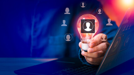 A person holding a light bulb, a humanoid icon, or the concept of human resource management. The merchant displays the manager icon, which is one of the employee icons for recruiting leaders copyspace