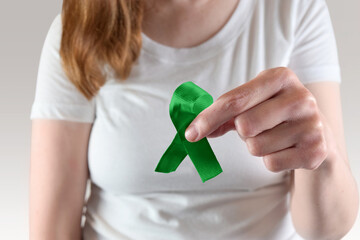 Mental Health Awareness Concept - Woman Holding Green Ribbon - Mental Illness, Glaucoma