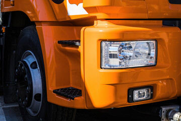 close-up part of orange truck front headlight