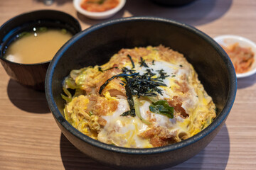 Delicious Katsudon Bowl with Soup and Gimji: A Tempting Japanese Delight in a Stylish Black Bowl