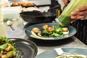 Chef working in busy kitchen preparing meals