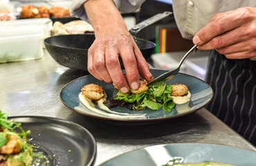 Chef working in busy kitchen preparing meals