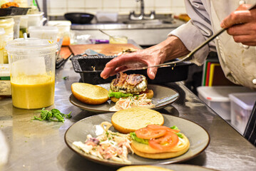 Chef working in busy kitchen preparing meals