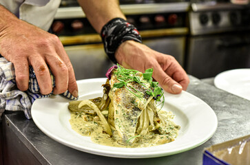 Chef working in busy kitchen preparing meals