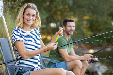 happy couple is enjoying fishing on sunny day