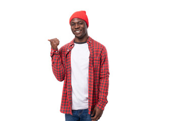 confident young ethnic african guy in stylish look pointing with index finger at promotional offer isolated on white background