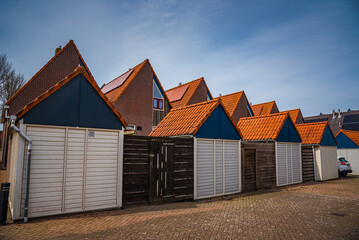 Fototapeta na wymiar Historic facades of houses at the Noorderhaven harbor of Harlingen, Netherlands