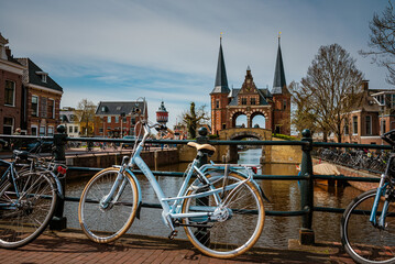 The famous Waterpoort gate in the port of Sneek with a typical means of transport (bicycle) in the foreground, Friesland, Netherlands.