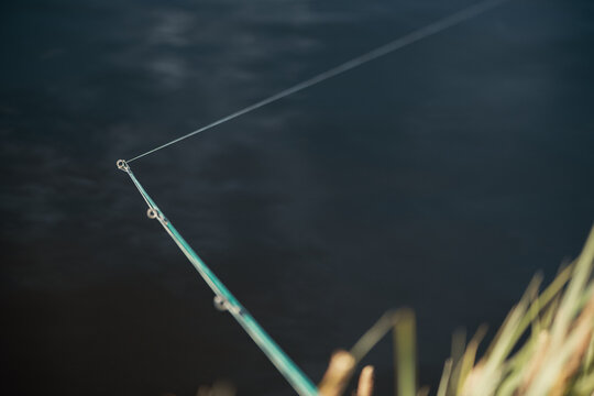Fishing rod with fishing line near water