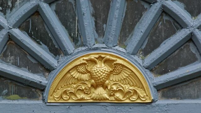 A closeup of a two-headed bird sculpture, or gandaberunda bird emblem