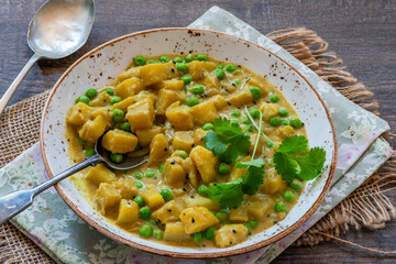 Coconut and potato curry with green peas