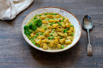 Coconut and potato curry with green peas