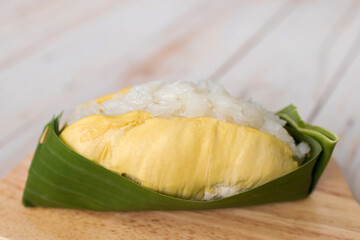 Durian with sweet sticky rice and coconut milk on top (Khao Niao Thu Lien). Thai style tropical dessert, glutinous rice eat with durian. 