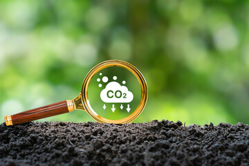 Icon Reduce CO2 emission in a magnifier glass to clean and friendly environment for Sustainable development and carbon credit to limit global warming from climate change. - obrazy, fototapety, plakaty