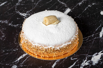 Banana and cream cake. German pie. Banana and cream cake on a dark background.