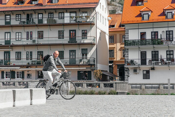 Portrait of a handsome hipster man. A man in a big city cycling down the street on a bicycle, a life style concept