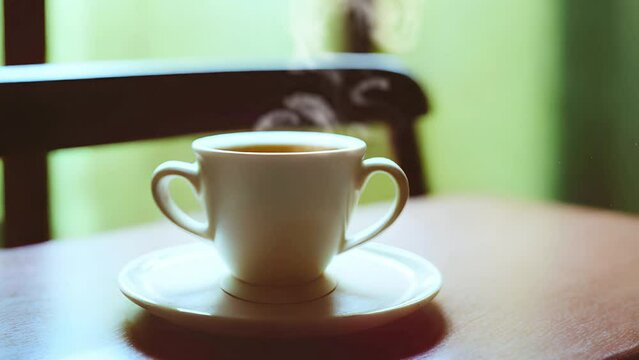 AI-generated image: a cup of hot coffee stands on a light brown surface. Steam rises over the cup.