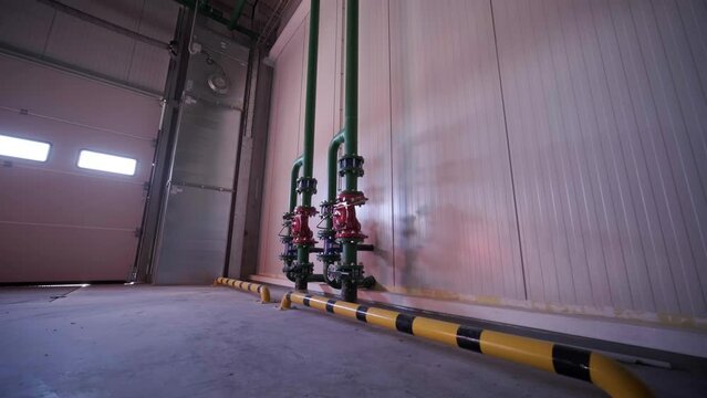The water-based fire protection system is installed at a large factory. There is a pipe with a sprinkler.