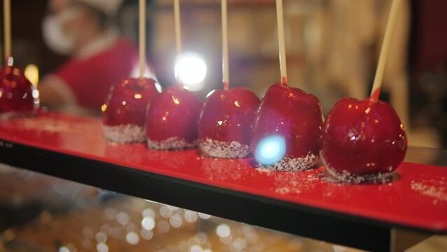 Hand dipped caramel covered apples decorated with nuts and chocolate in the evening at the hotel. The power system is all inclusive.