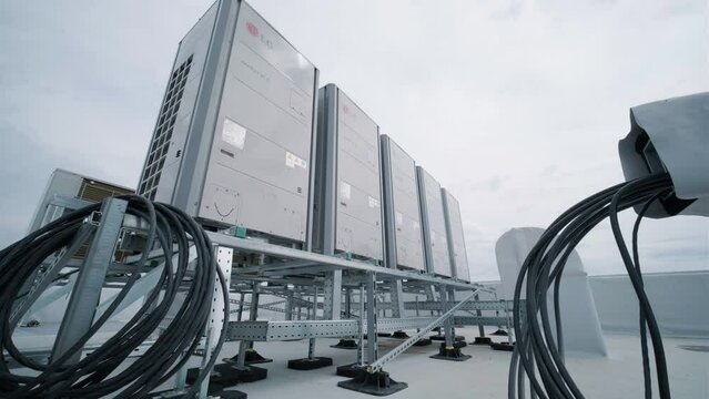 KYIV, UKRAINE - APRIL 2023: The air conditioning and ventilation system of a large industrial facility is located on the roof. It includes an air conditioner, smoke exhaust, and ventilation.