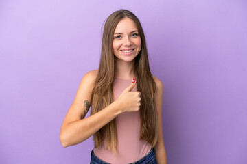 Young Lithuanian woman isolated on purple background giving a thumbs up gesture