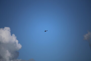 helicopter isolated in blue expansive sky