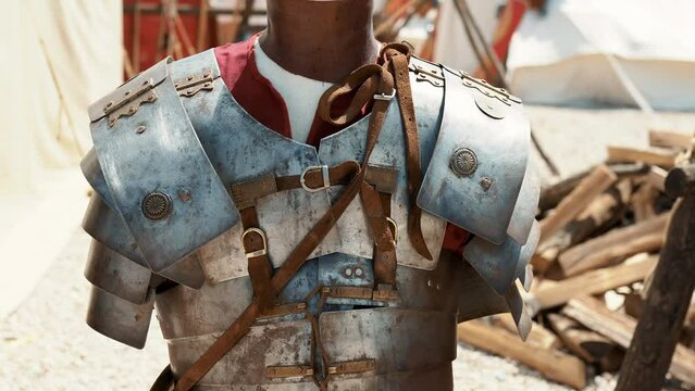 Protective armour clothing of Roman legionaries in military camp, linen tunic, leather waist and sandals, protective ornate helmets, shields, swords and spears for battles of powerful Roman Empire