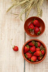 Red berries, strawberries in clay bowls, on a white table, dry ears of corn, background image, background, wallpaper for presentations, summer, spring
