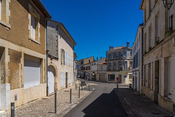 Fototapeta na wymiar A narrow street between houses in a small French town