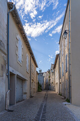 narrow street with stone walls on both sides in France