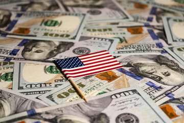 American Flag on a Bed of Dollar Bills. american flag on us dollars background