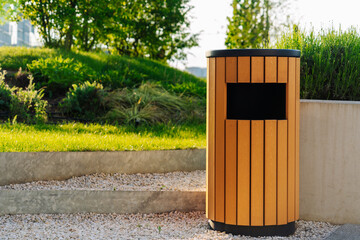 New wooden trash can in city park.
