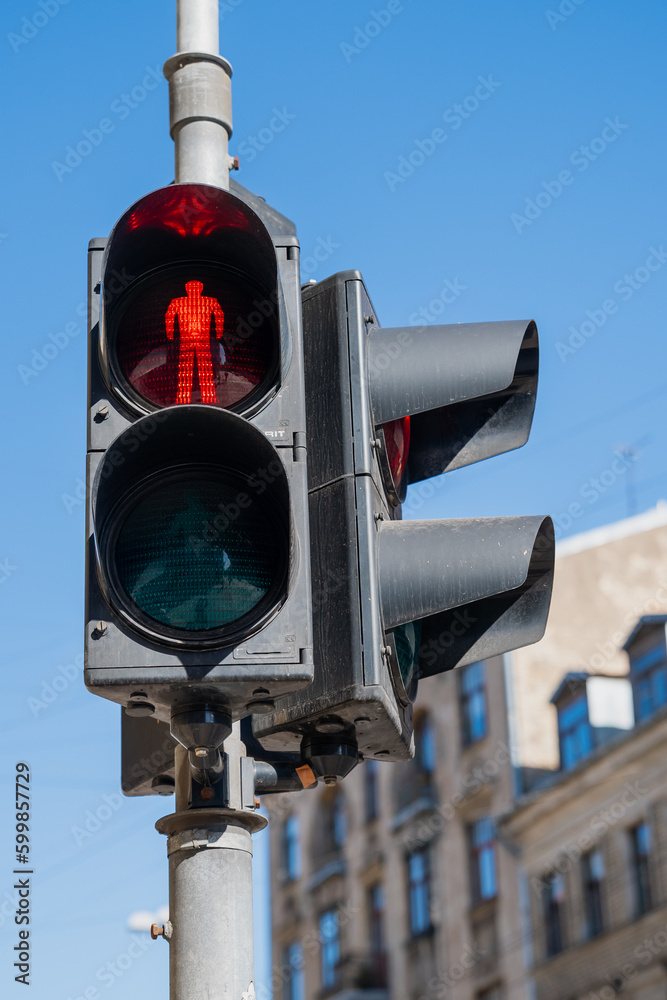 Poster Red pedestrian traffic light on blue sky background