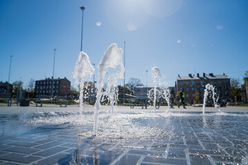 Pavement fountain in children's park with fresh water coming out of the ground