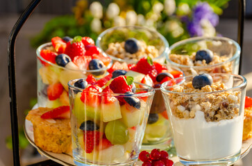 Breakfast with yogurt, muesli and fruits salad.